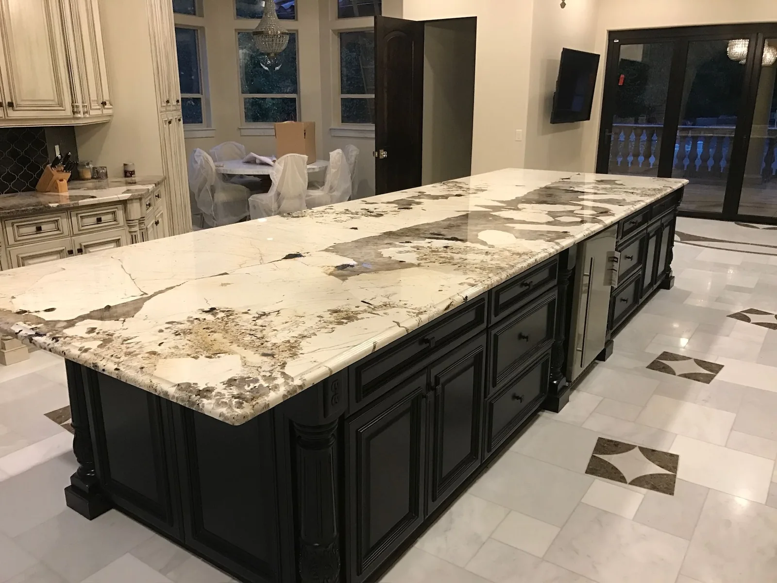 Bold veined island countertop on black cabinets