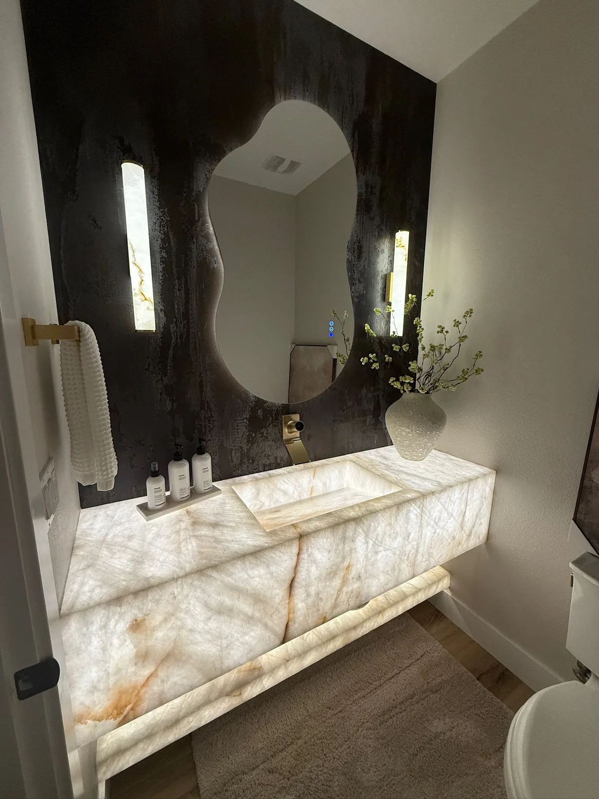 Backlit floating vanity in a powder room