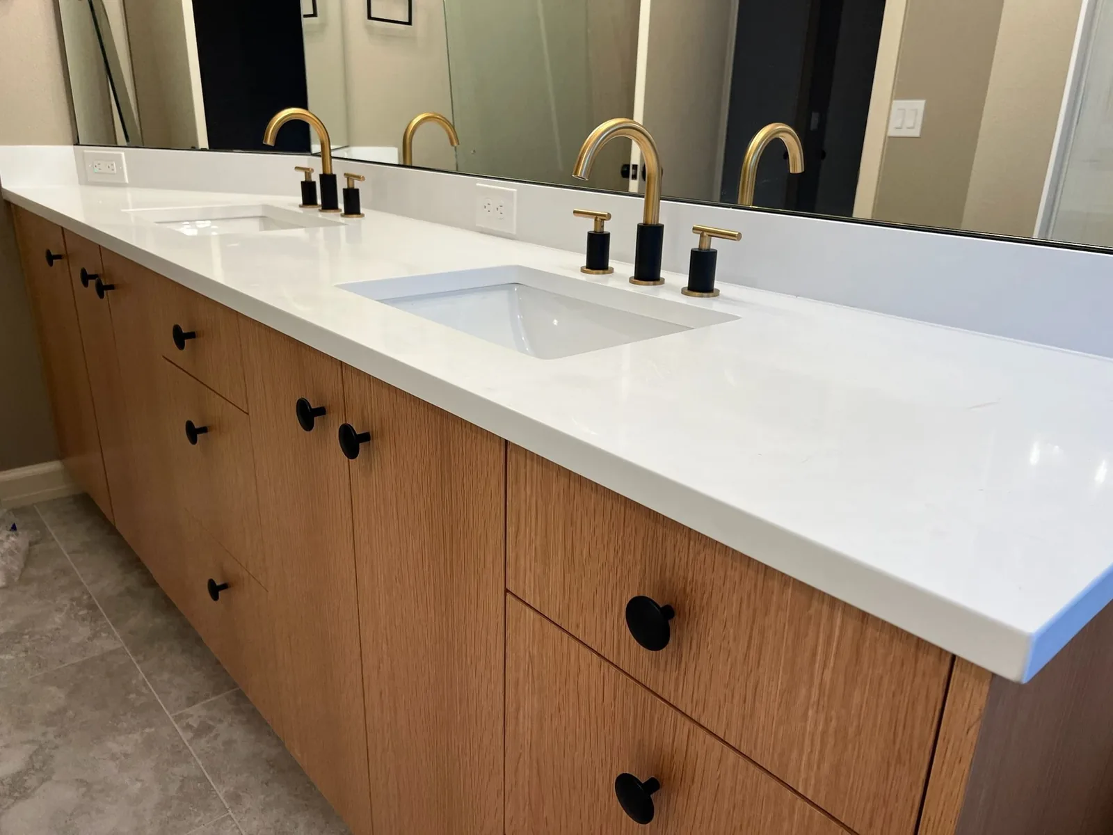 White double vanity countertop with gold faucets