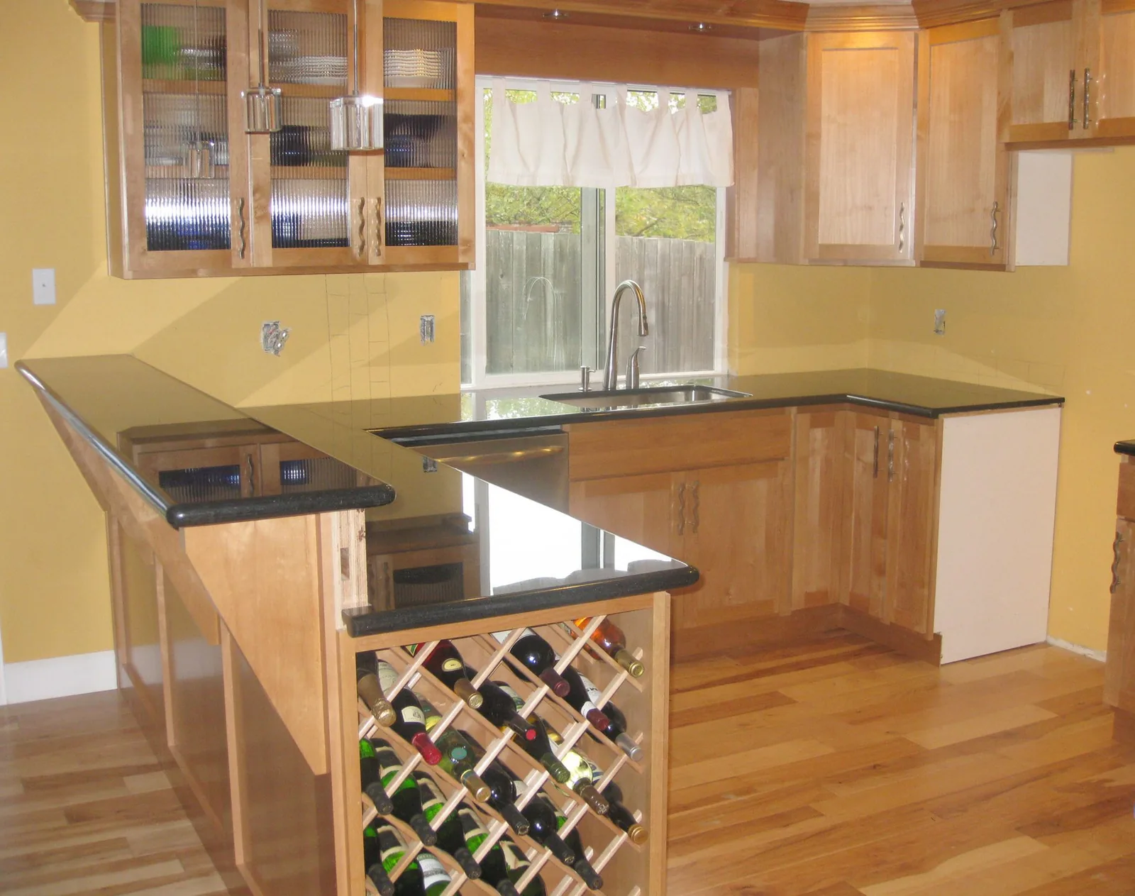 Black bar countertop and peninsula with a wine rack