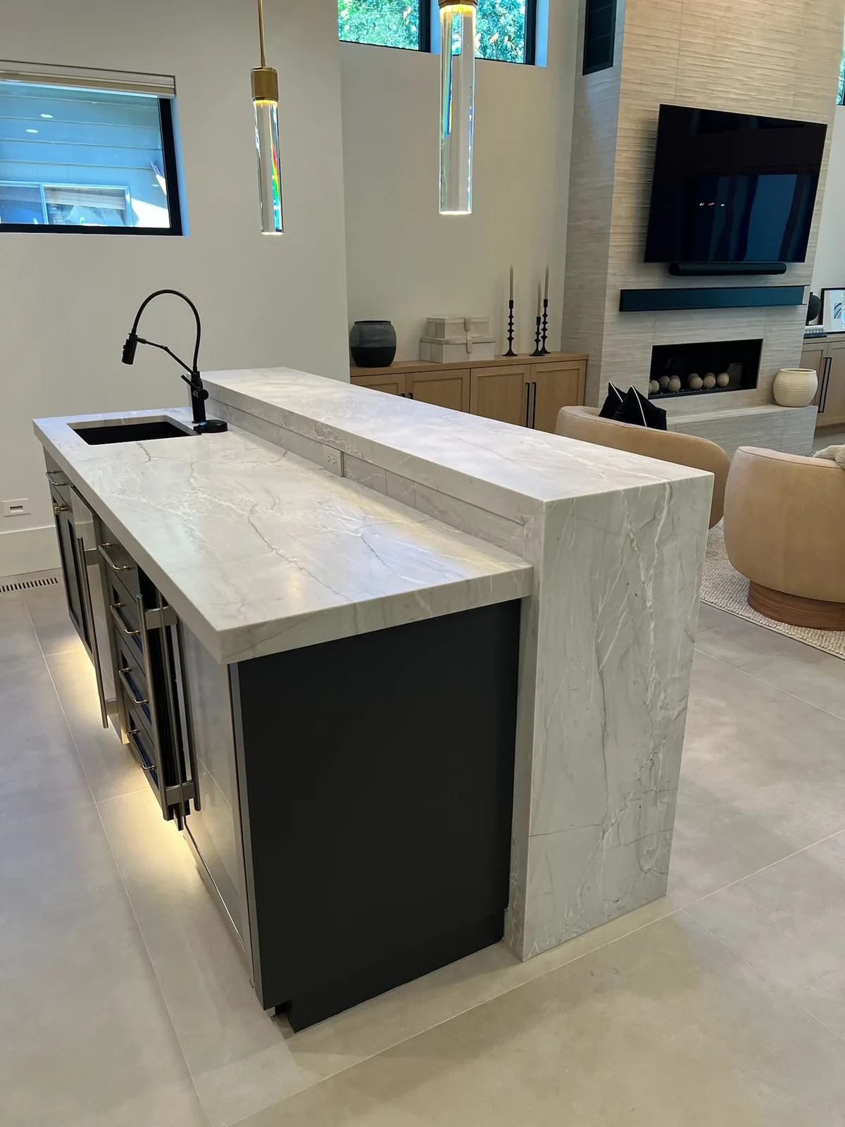 Waterfall bar island with a prep sink